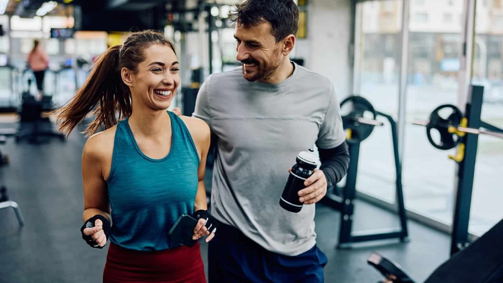Two smiling people working out with Makasa Etch Blueprint in gym.